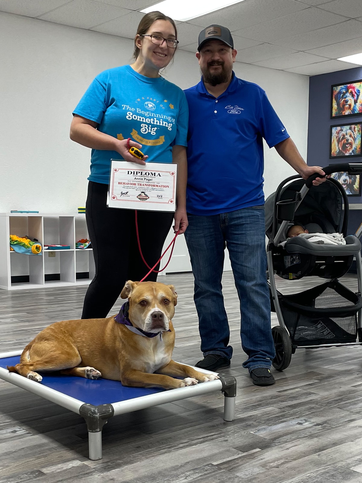 Annie the dog with owners and training certificate